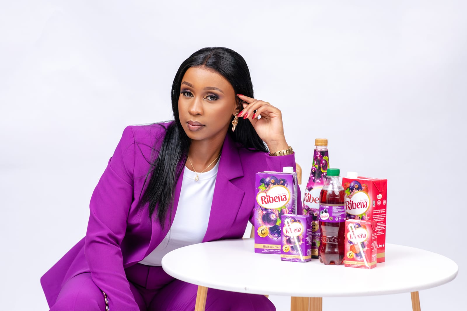 Joy Mido in a purple suit creating branded content